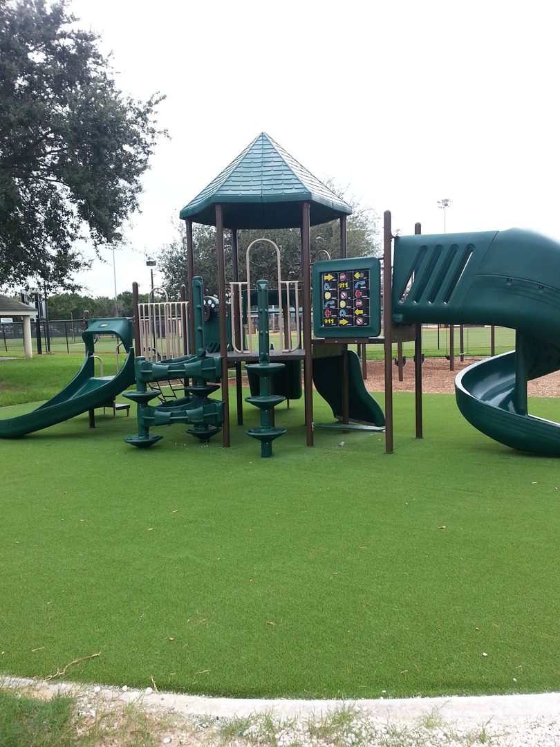 A green slide on a playground