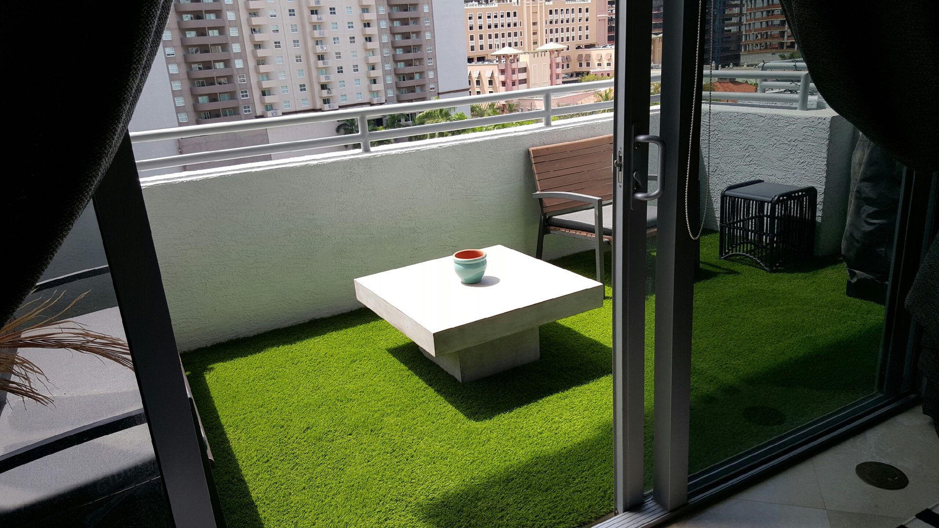 A balcony with grass flooring