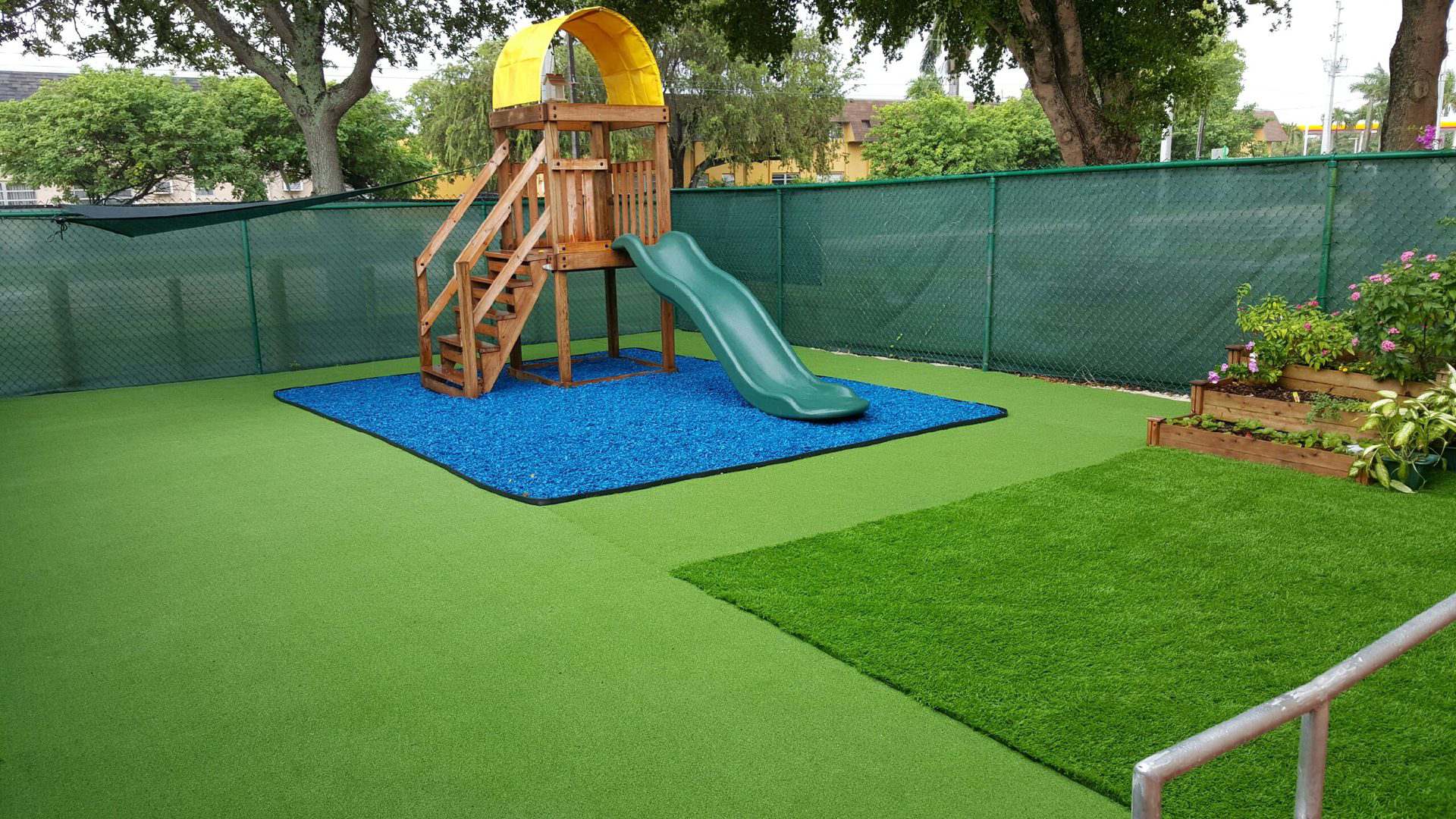A slider for children with blue grass mat